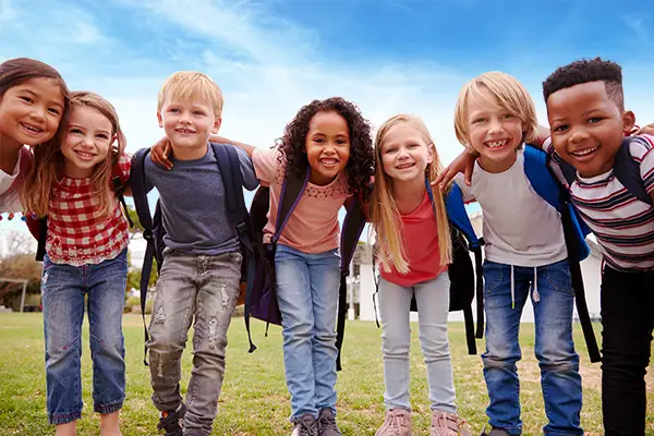 The Merit School - Childcare and Private School in Virginia - group of happy children arm-in-arm outside