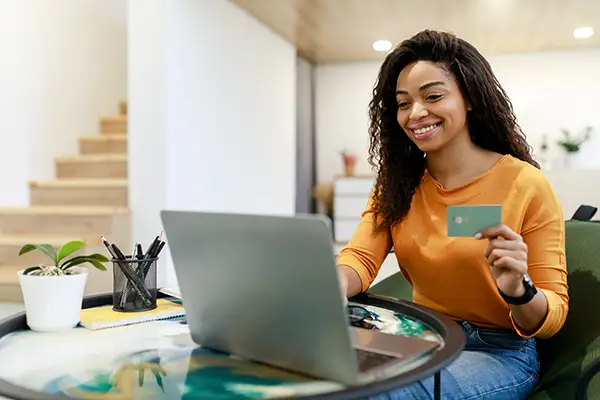 Pay Tuition at The Merit School - lady with credit card in hand making online payment