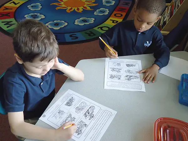 The Merit School Private School Elementary students learning with illustrated worksheets