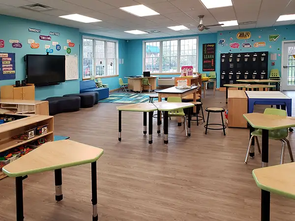 Before and After School Daycare - The Youth Zone Childcare at Merit School - large, bright, clean room with toys, books, a TV, comfortable seating, desks, computers, lockers, and more