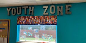 Merit School at the Castle school-age care area "Youth Zone" wall sign