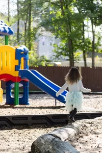 Merit Castle playground - girl on log